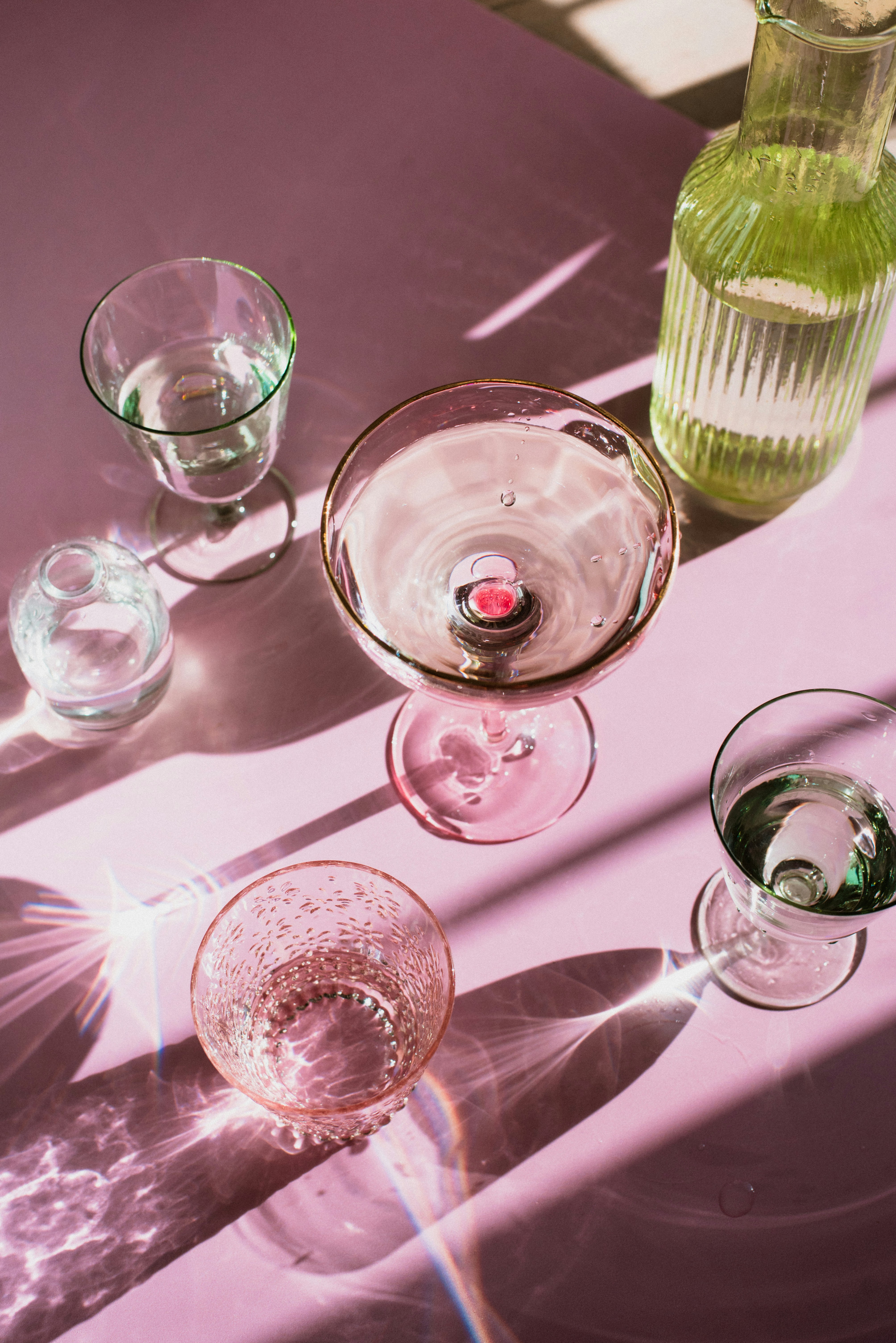 Overhead glassware casting shadows on a purple surface